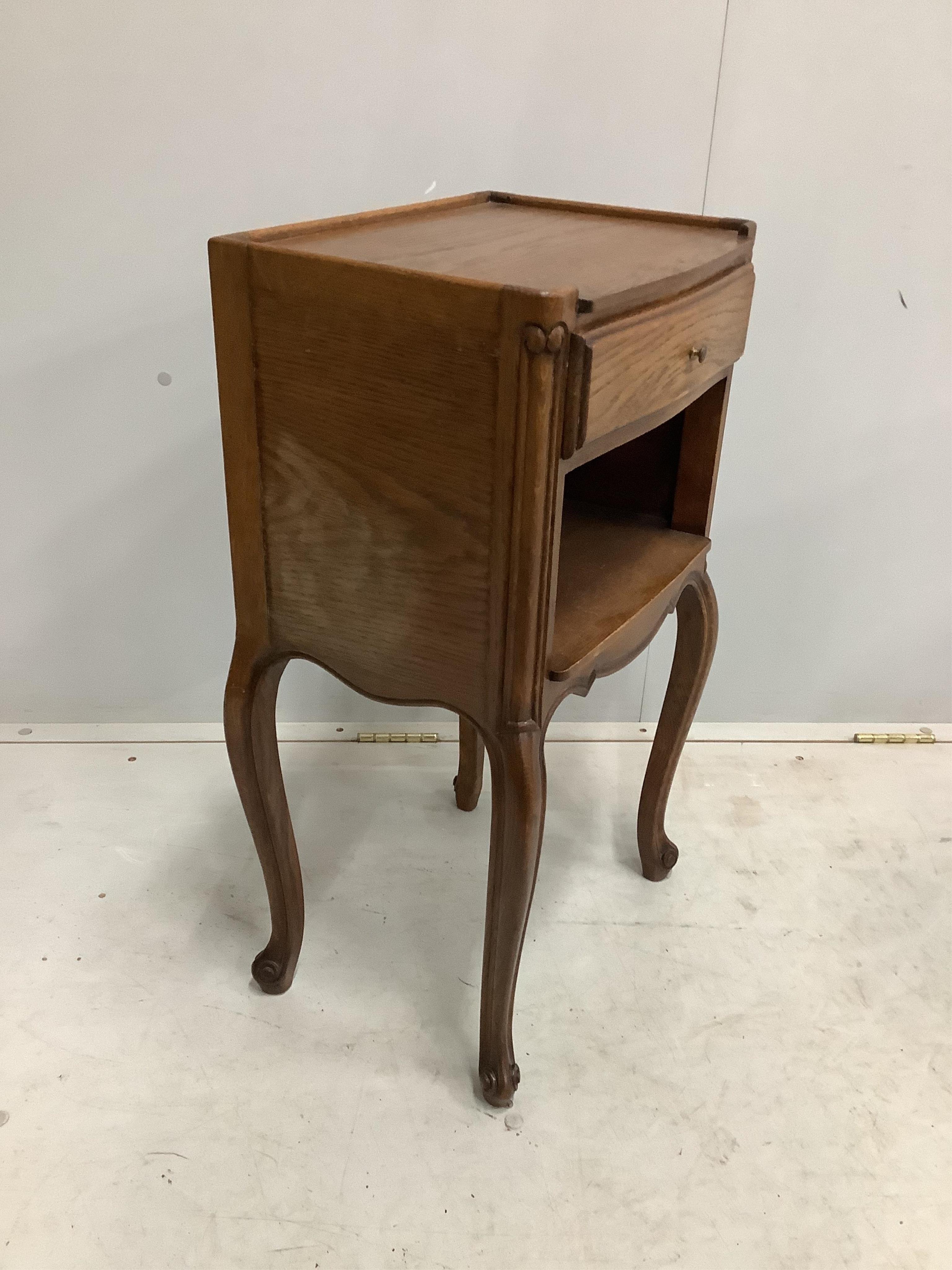 A pair of French oak bedside cabinets, width 38cm, depth 28cm, height 70cm. Condition - fair to good